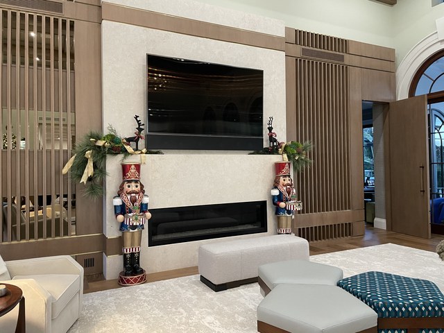 A slatted feature wall with two nutcrackers flanking a linear fireplace