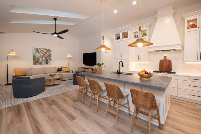 The kitchen and living room seen together across the island seating